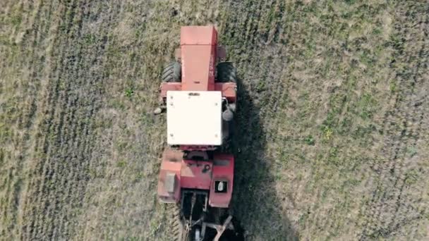 Aerial top view of tractor plowing the soil. — Stock Video