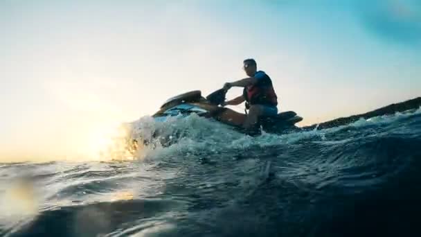 Splashes formed by a jet ski driven by a rider. — Stock Video