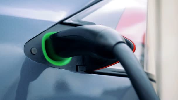 Electric car recharging outdoors, close up. — Stock Video