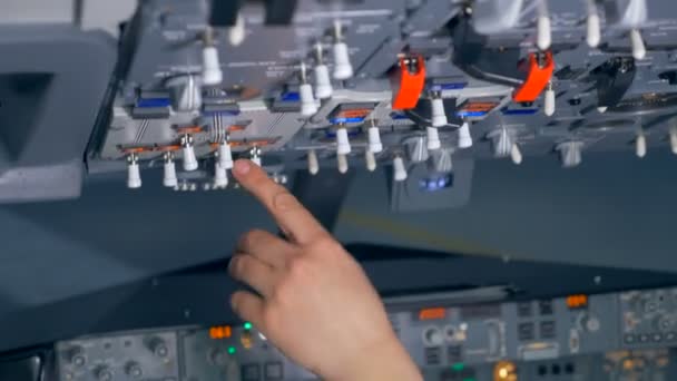 A person adjusts buttons on a dashboard, close up. — Stock Video