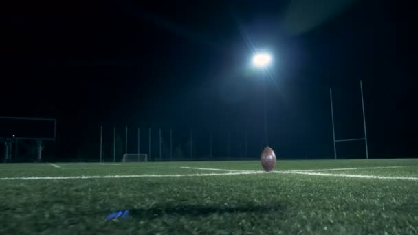 American football field with a rugby player hitting the ball — Stock Video