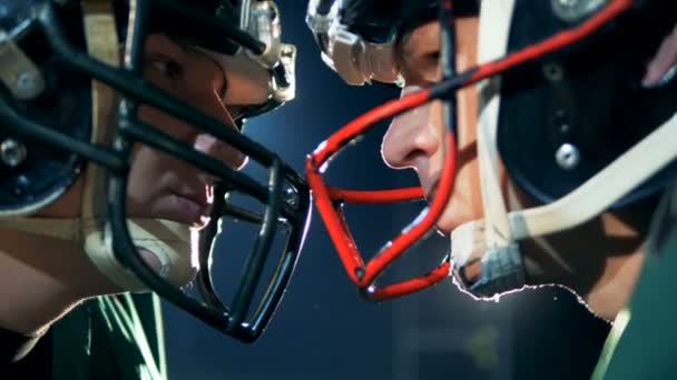 Two American football athletes are standing head to head on a stadium — Stock Video