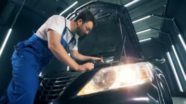 Bir dizüstü bilgisayar ile bir teknisyen tarafından işlem bir otomobil tamir yürütülen