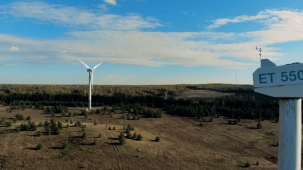 Functioning windmills, wind energy turbines installed in the open terrain. Green energy concept. — Stock Video