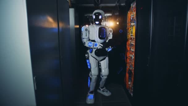 Un robot marche dans un couloir à un centre de données, gros plan .