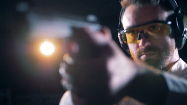 Shooter ετοιμάζεται να φωτιά κρατώντας ένα πιστόλι — Αρχείο Βίντεο