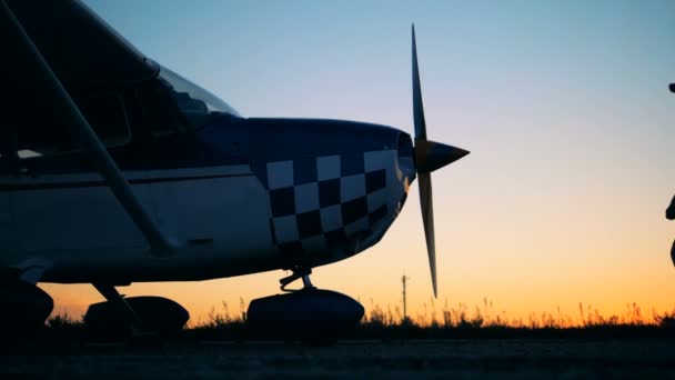 Airplane pilot standing on a sunset background, close up. — Stock Video