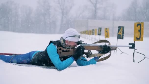 Female biathlete is shooting in the middle of a biathlon training — Stock Video
