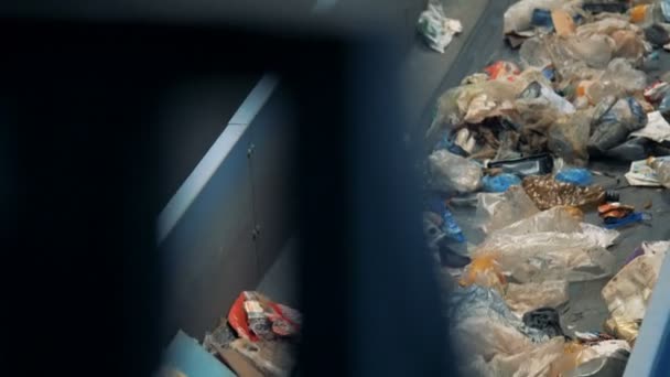 Dirty garbage on a conveyor, close up. — Stock Video