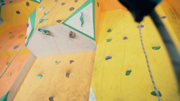 Yellow climbing wall of a bouldering gym — Stock Video