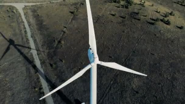 Wind generators produce energy on a field. Renewable energy concept. — Stock Video