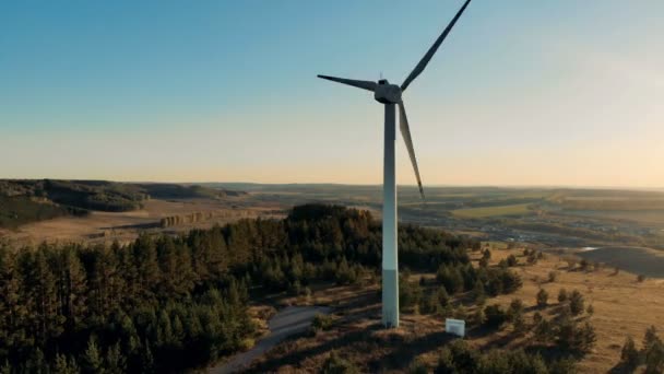 Un aerogenerador trabajando sobre un fondo de puesta de sol. Concepto de energía renovable . — Vídeos de Stock