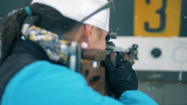 Female biathlete is shooting and one target is being closed — Stock Video