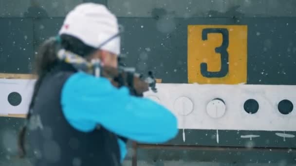Targets on a panel are closing after lady biathlete shooting them — Stock Video