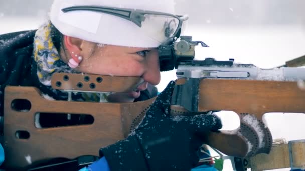 Vista lateral de una deportista disparando y recargando el rifle — Vídeo de stock