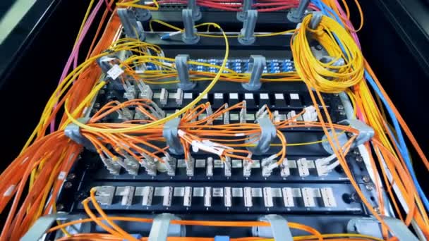 Set of data servers linked by multicolour wires — Stock Video