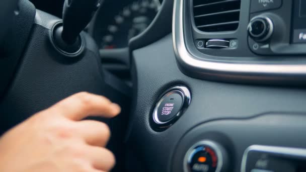 Engine start and stop button is being pushed with a finger — Stock Video