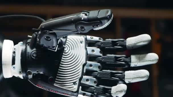 Fist of a robotic arm is clenching while its getting lowered — Stock Video