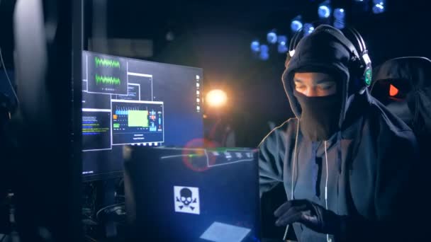 Hacking process of a male hacker in a hideout place — Stock Video