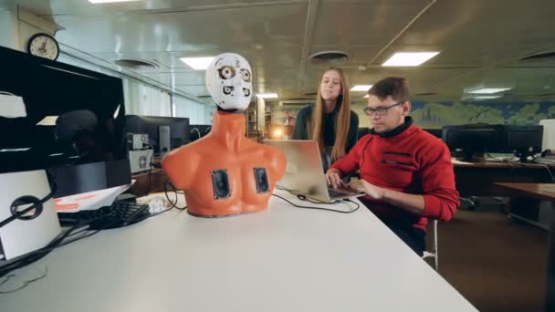 De jeunes ingénieurs manipulent un cyborg pour déplacer ses organes faciaux — Video