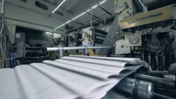 Печатный станок выпускает сложенные страницы бумаги — стоковое видео