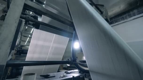 Paper moving on rollers in a print office, close up. — Stock Video