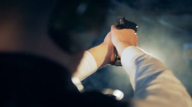 Bir tetikçi ateş silah, arkadan görünüm.