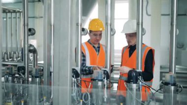 Bira fabrikası makineleri, kontrol işçiler yakın çekim.