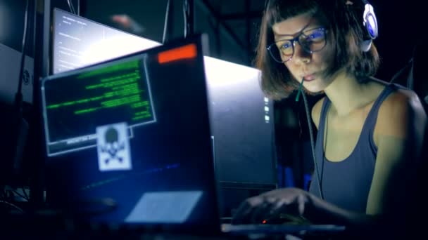 Une fille pirate un ordinateur dans une pièce sombre — Video