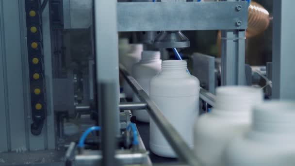 Plastic bottles going through pressing mechanical equipment — Stock Video