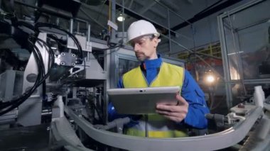 Bir tablet ile erkek uzmanı plastik şişe kemer hareket gözlemleyerek