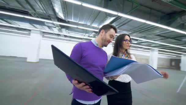 Engenheiros profissionais usam laptop enquanto discutem um projeto de trabalho em uma sala . — Vídeo de Stock