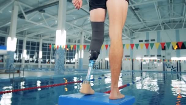 Gehandicapte man opleiding bij een zwembad, bionic been prothese. — Stockvideo