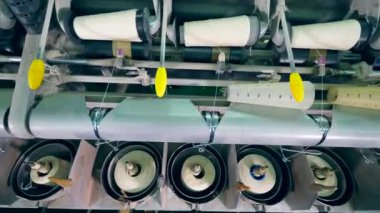 Bir tekstil fabrikasında endüstriyel makine üzerinde dikiş biriktiricileri sürecinin sarma yürütülen.