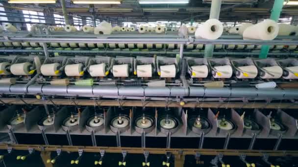 Textile factory unit with white threads getting wound — Stock Video