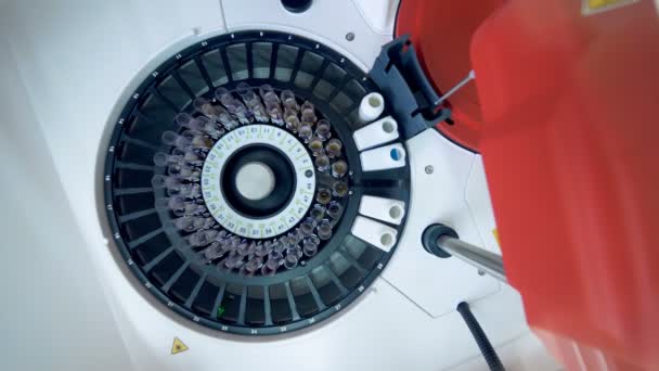 Автоматизированная машина проверяет трубы с образцами крови в лаборатории . — стоковое видео