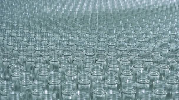 Empty glass bottles stacked together and moving slowly — Stock Video