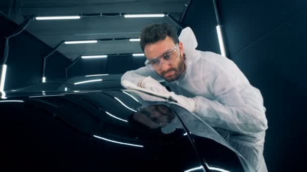 Superficie auto viene pulito con un panno da un lavoratore maschio — Video Stock
