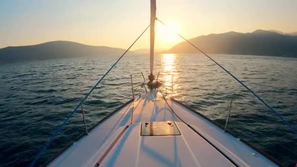Un yate está lentamente a la deriva a través del paisaje acuático puesta de sol — Vídeos de Stock