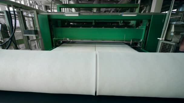 Plant conveyor coils synthetic fabric into big rolls. — Stock Video
