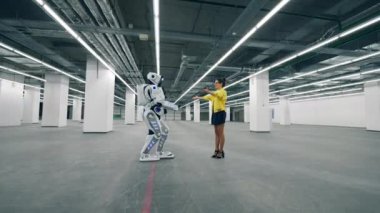 Kişi ve cyborg bir odada buluşuyorlar, birbirlerine sarılıyorlar..