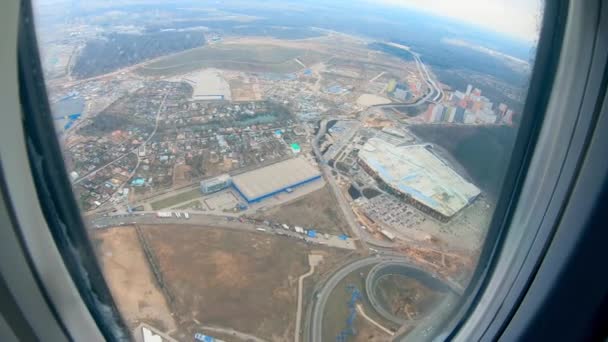 The buildings are being shown from an aircraft porthole — Stock Video