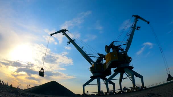 Schottersteine werden an Docks von hohen Kränen entladen. — Stockvideo