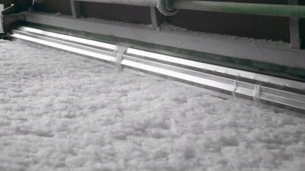 Metal rollers works with thin synthetic fiber on a conveyor. — Stok video