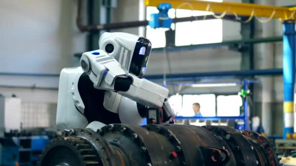 Industrial mechanism is being drilled by a cyborg — Stock Video