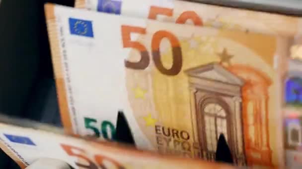 Fresh euro banknotes move on a line in a banking counter. — Stock Video