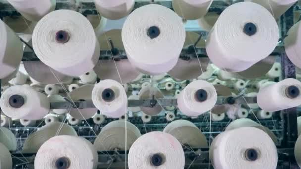 Bobinas giratorias con hilos blancos. Línea de producción de textiles — Vídeo de stock