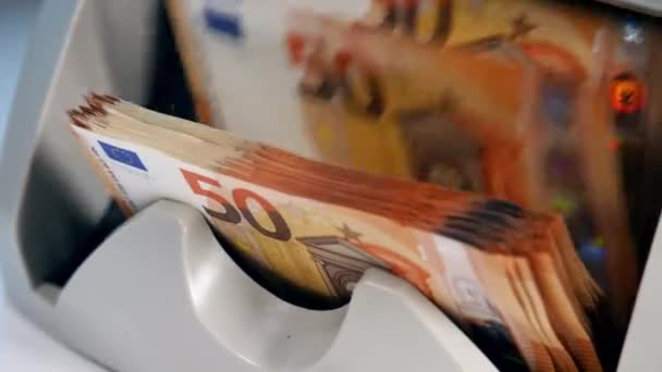 Persoon gebruikt telapparaat om de afgedrukte Euro's te controleren. — Stockvideo