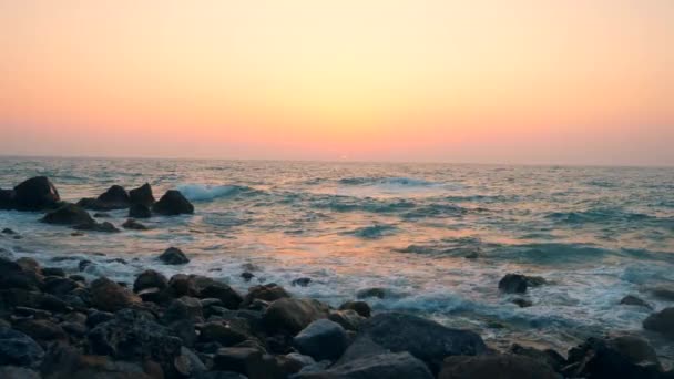 Sea and rocky coastline on a sunset background. — Stock Video