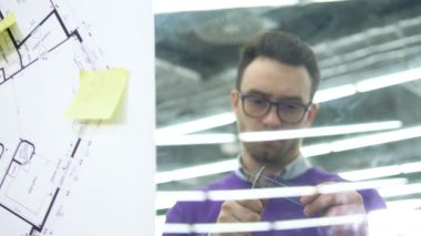 Bir mühendis, uzman plastik bir tahta üzerinde hesaplamalar yapıyor